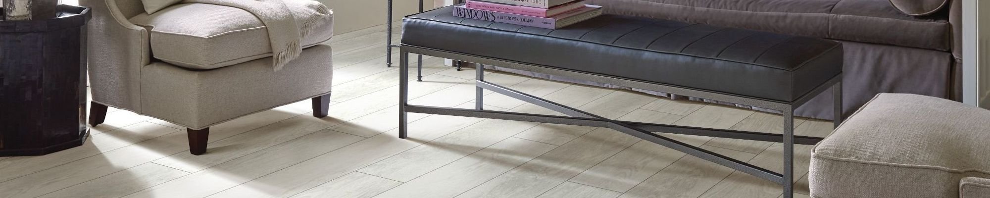 beige armchairs and black coffee table in living room with white hardwood flooring