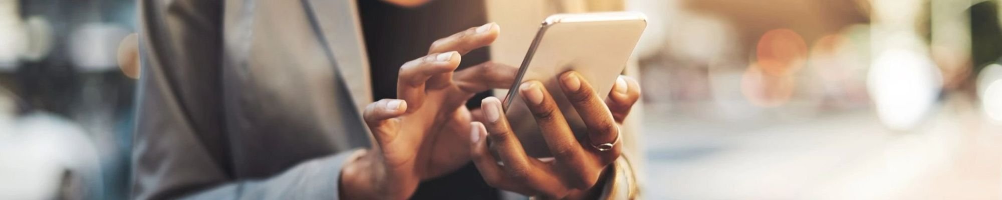 A woman is texting something on her mobile phone.